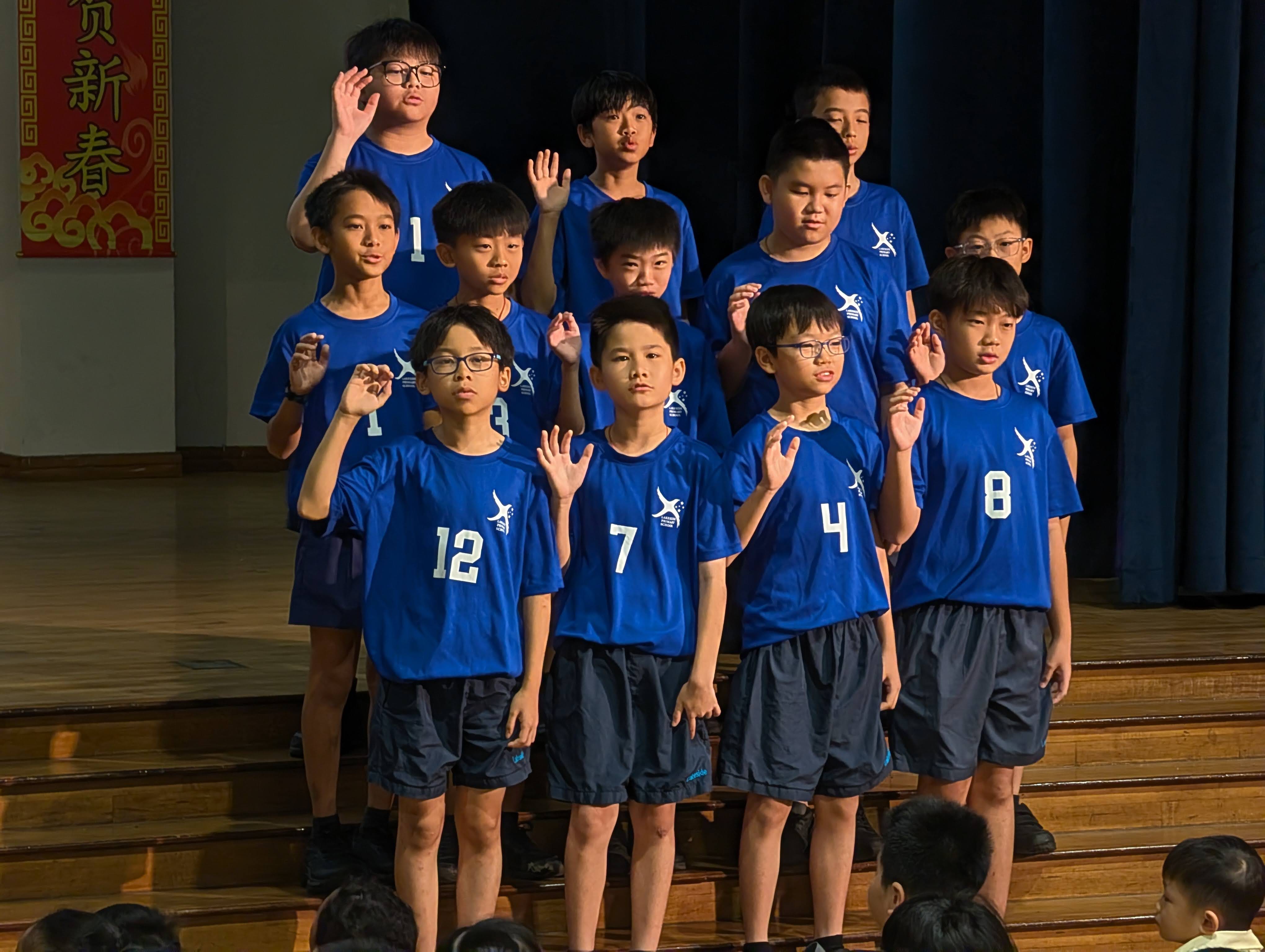 Volleyball Senior Boys team taking part in the Athlete's Oath on stage